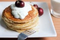 Breakfast whole wheat pancakes with cherry and yogurt