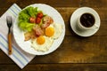 Breakfast on a wooden table. Coffee fried egg with bacon. Royalty Free Stock Photo