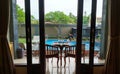 Breakfast on a wooden table on the veranda by the pool on Bali Island Royalty Free Stock Photo