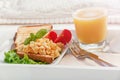 Breakfast on a wooden tray eggs scrambled and juice