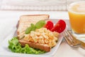 Breakfast on a wooden tray eggs scrambled and juice