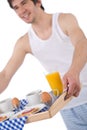 Breakfast - young man holding tray toast and juice Royalty Free Stock Photo