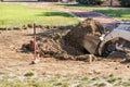 Breaking Ground Small Bulldozer Digging In Dirt and Grass Royalty Free Stock Photo