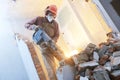 Breaking interior wall. worker with demolition hammer Royalty Free Stock Photo