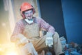 Breaking interior wall. worker portrait with demolition hammer Royalty Free Stock Photo