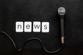 Breaking news concept. Microphone on black background top-down Royalty Free Stock Photo