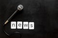 Breaking news concept. Microphone on black background top-down copy space Royalty Free Stock Photo