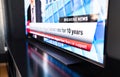 Breaking news on tv. Live newscast headline. Television on table, screen close up. Daily morning show broadcast. Misinformation. Royalty Free Stock Photo