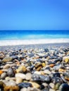 Breaking Wave of Blue Ocean on Pebbles beach Summer Background Royalty Free Stock Photo