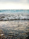 Breaking Wave of Blue Ocean on Pebbles beach Summer Background Royalty Free Stock Photo