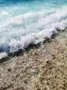 Breaking Wave of Blue Ocean on Pebbles beach Summer Background Royalty Free Stock Photo