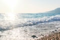 Breaking Wave of Blue Ocean on Pebbles beach Summer Background Royalty Free Stock Photo