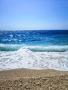 Breaking Wave of Blue Ocean on Pebbles beach Summer Background Royalty Free Stock Photo