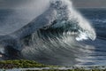 Breaking wave rises up in backwash Royalty Free Stock Photo