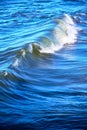 Breaking wave in stormy blue sea