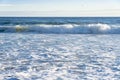 Breaking waves and and beach foam