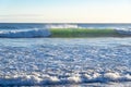 Breaking waves and and beach foam