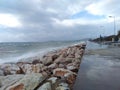 Breaking waves, promenade and Athens cityscape Royalty Free Stock Photo