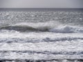 Breaking waves and seaspray, no land, Bad weather sea background. UK grey. Royalty Free Stock Photo