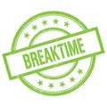 BREAKTIME text written on green vintage stamp