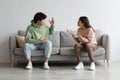 Breakup and divorce concept. Young married Asian couple having fight, yelling at each other in living room Royalty Free Stock Photo