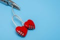 Breakup love connection concept. Disconnection of two hearts in the form of locks on a blue background