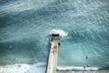 A breakwater in the sea and many people having a rest, a view from above.