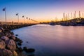 Breakwater and boats at the harbor at sunset, in Santa Barbara,