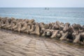 Breakwater coastal protection constructed from prefabricated cement blocks to reduce the intensity of wave action.