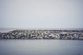 The breakwater in the form of a strip of stones stretches out into the sea Royalty Free Stock Photo