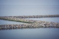 The breakwater in the form of a strip of stones stretches out into the sea Royalty Free Stock Photo
