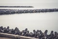 The breakwater in the form of a strip of stones stretches out into the sea Royalty Free Stock Photo