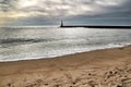 Breakwater with lighthouse on Aguda Beach