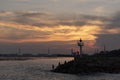 Breakwater rock line with light house against sunset light Royalty Free Stock Photo