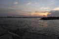 Breakwater rock line with light house against sunset light Royalty Free Stock Photo