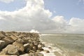 Breakwater with roughened sea and cloudy sky Royalty Free Stock Photo