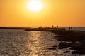 breakwater in the sea with red lighthouse at the end Royalty Free Stock Photo