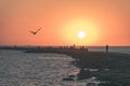 breakwater in the sea with red lighthouse at the end - vintage r Royalty Free Stock Photo