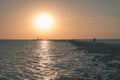 breakwater in the sea with red lighthouse at the end - vintage r Royalty Free Stock Photo