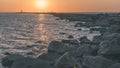 breakwater in the sea with red lighthouse at the end - vintage r Royalty Free Stock Photo