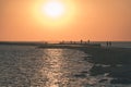 breakwater in the sea with red lighthouse at the end - vintage r Royalty Free Stock Photo