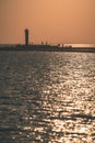 breakwater in the sea with red lighthouse at the end - vintage r Royalty Free Stock Photo