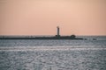 breakwater in the sea with red lighthouse at the end - vintage r Royalty Free Stock Photo