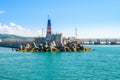 Breakwater and seamark on the blue sea