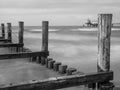 Breakwaters in the Baltic Sea at Zingst with pier in the background, monochrome Royalty Free Stock Photo