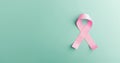 Breast Cancer Awareness Campaign Concept. Women Healthcare. Close up of a Pink Ribbon Lying on light blue background