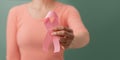 Breast Cancer Awareness Campaign Concept. Women Healthcare. Close up of a Young Female Brings a Pink Ribbon into the Front