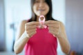 Breast cancer awareness concept,Asian woman hands holding pink ribbon Royalty Free Stock Photo