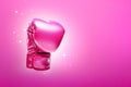 Breast cancer awareness concept with glittering pink boxing gloves for girl and woman fight with illness on pink background