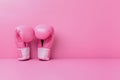 Breast cancer awareness concept with glittering pink boxing gloves for girl and woman fight with illness on pink background